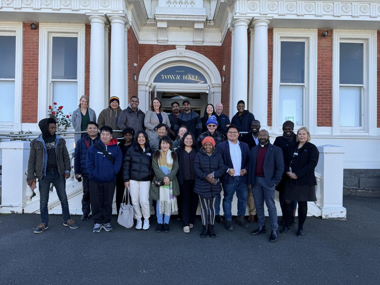 Group of 30 people standing outside Ararat Town Hall and smiling for camera