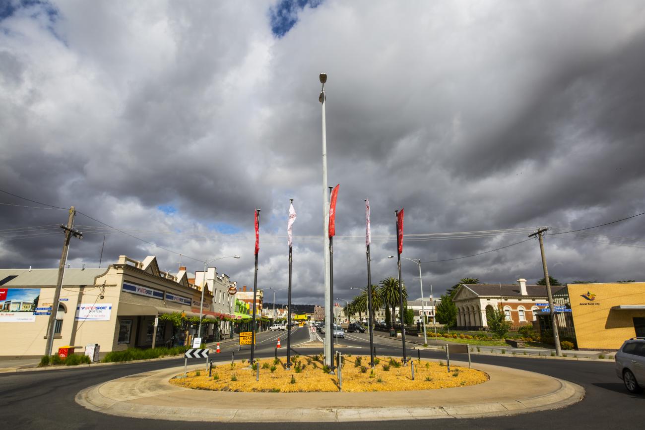 Roundabout in a local street with flags and flowers