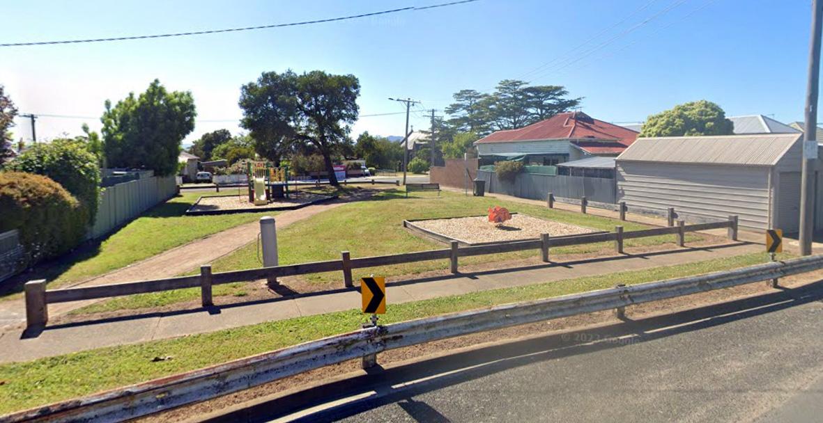 A suburban street with a small park attached